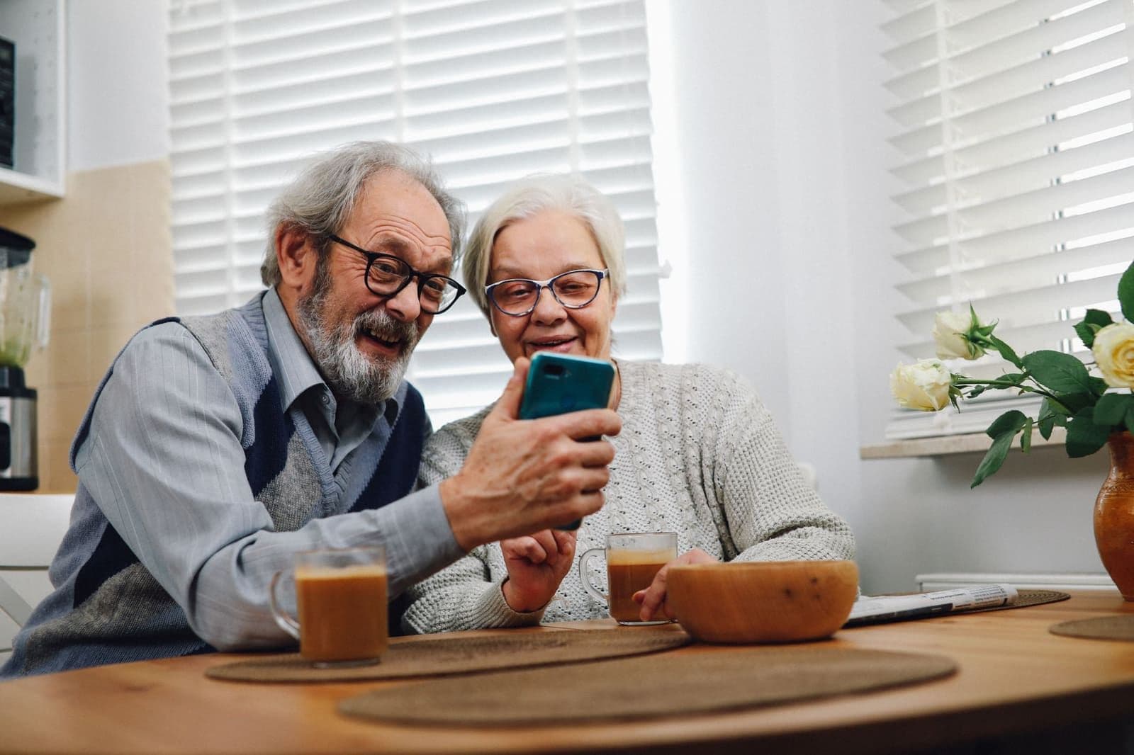 An older couple reading the AARP life insurance mailing from New York Life at their kitchen table
