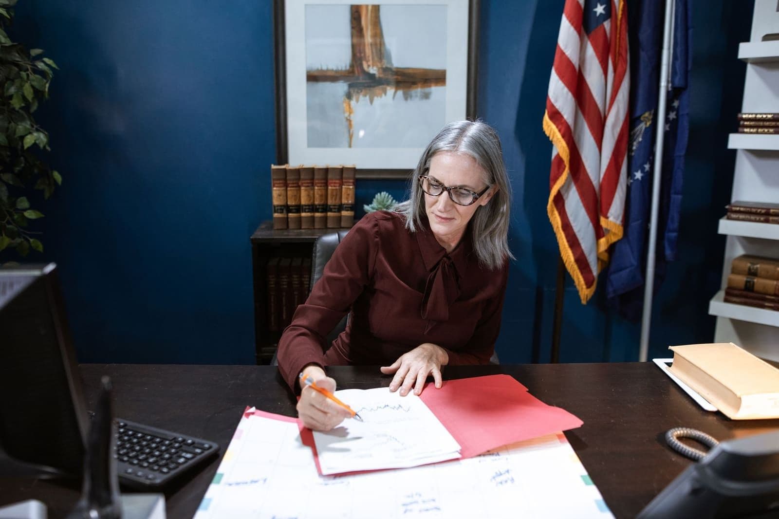 A woman comparing American Amicable life insurance plan details at home