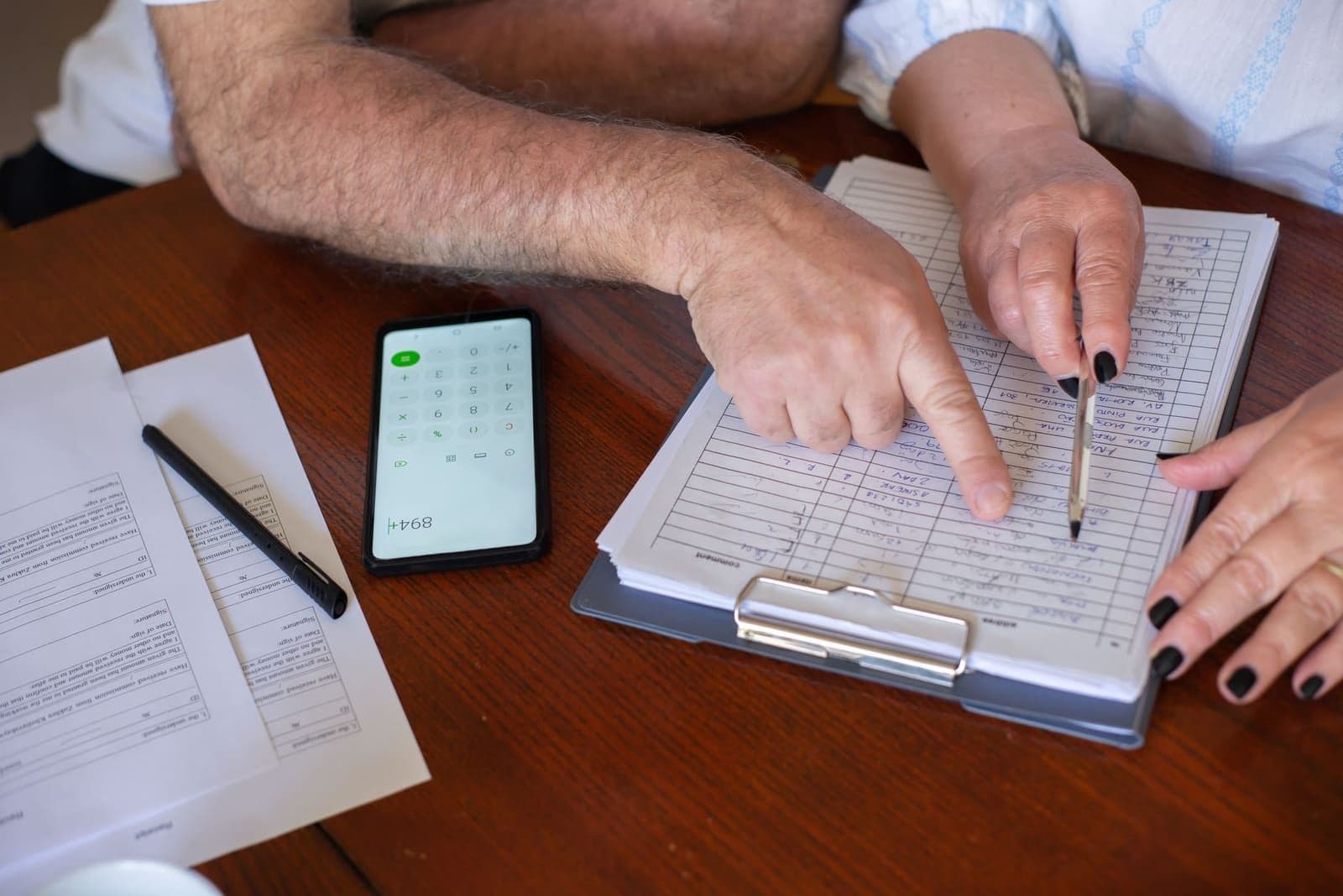 An older couple reviewing a Colonial Penn life insurance policy at their kitchen table
