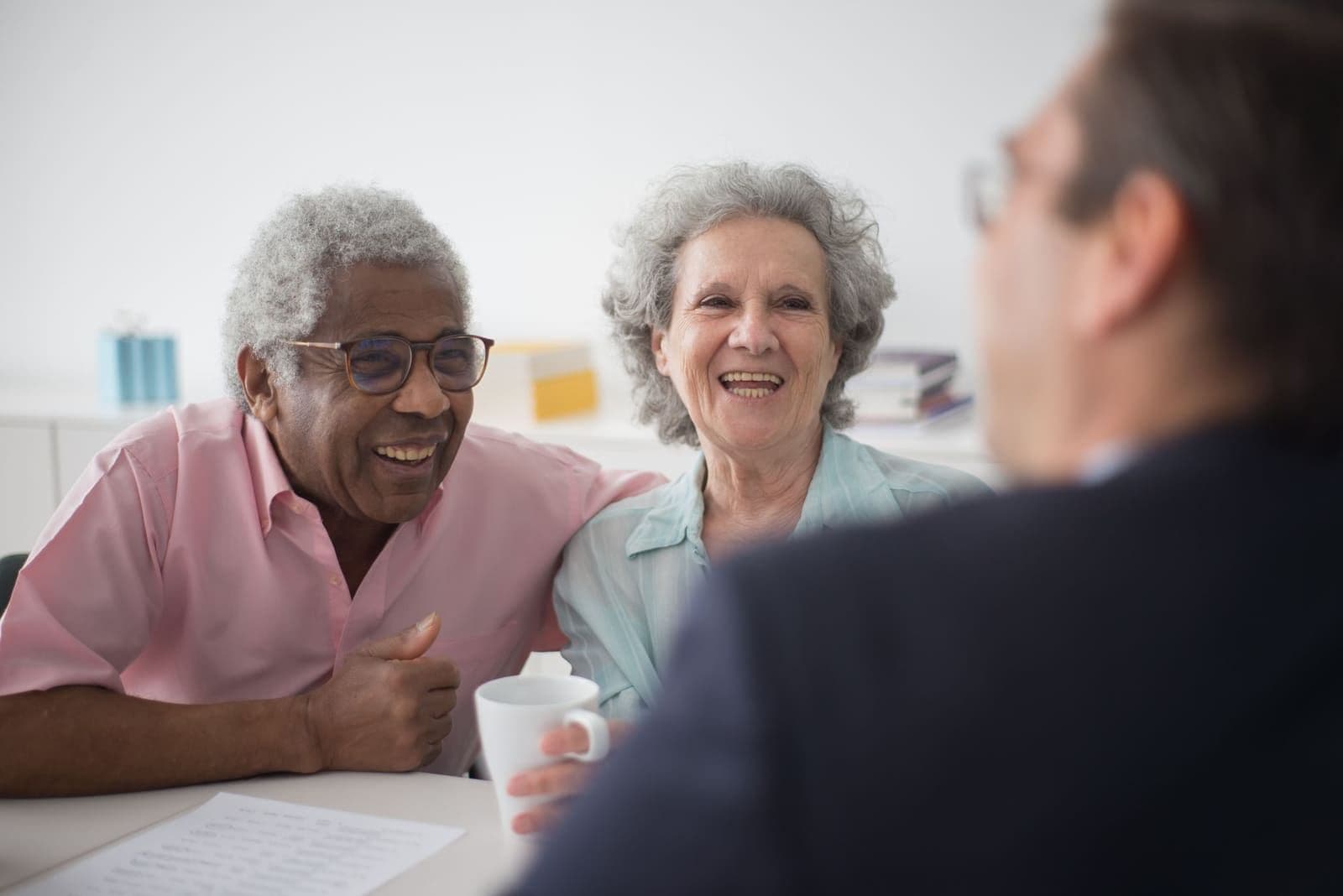 A senior couple reviewing a Senior Life Insurance Company final-expense policy with a licensed professional