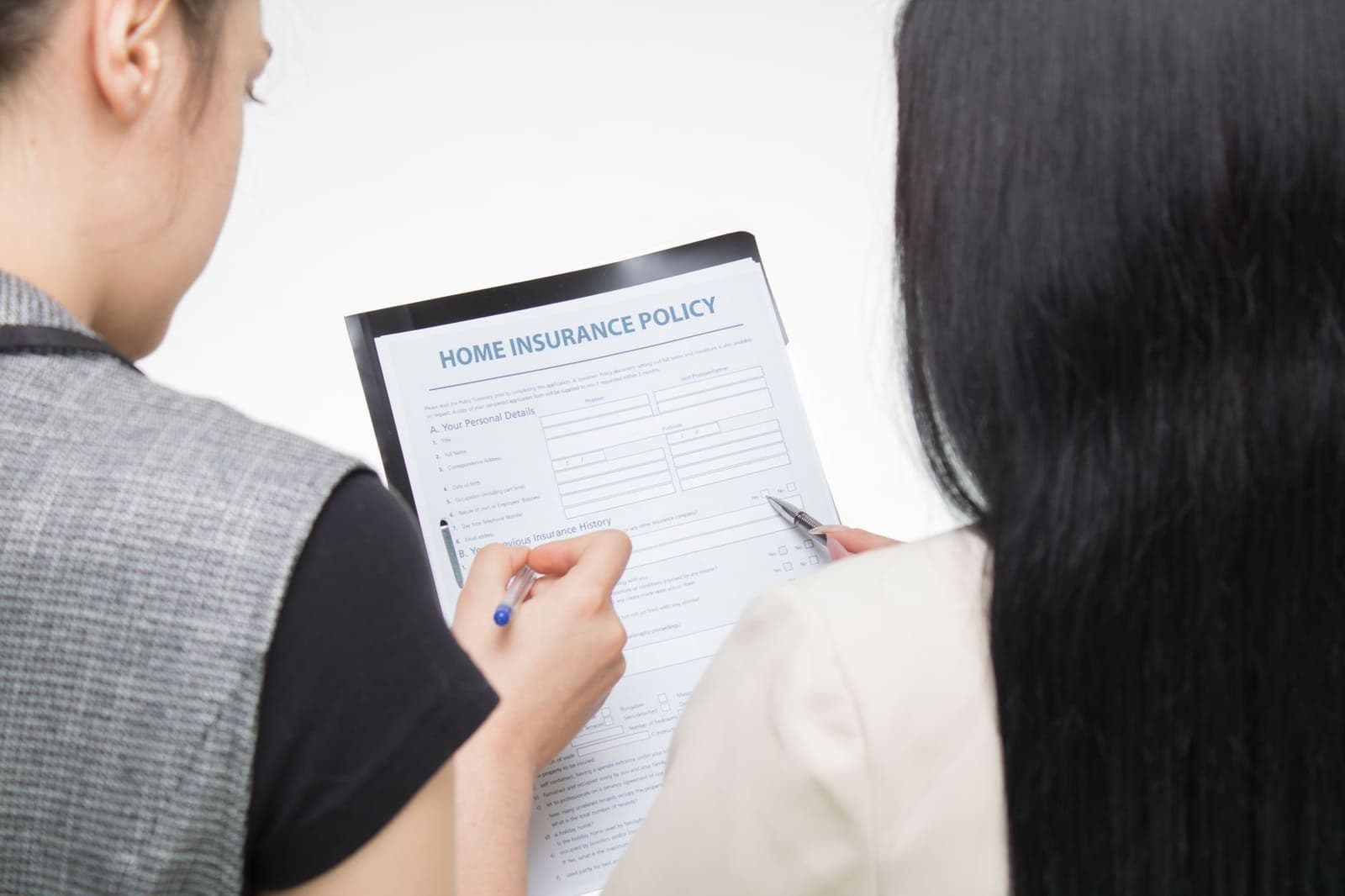 A couple at a kitchen table reviewing a National Life Group indexed universal life policy with a licensed professional