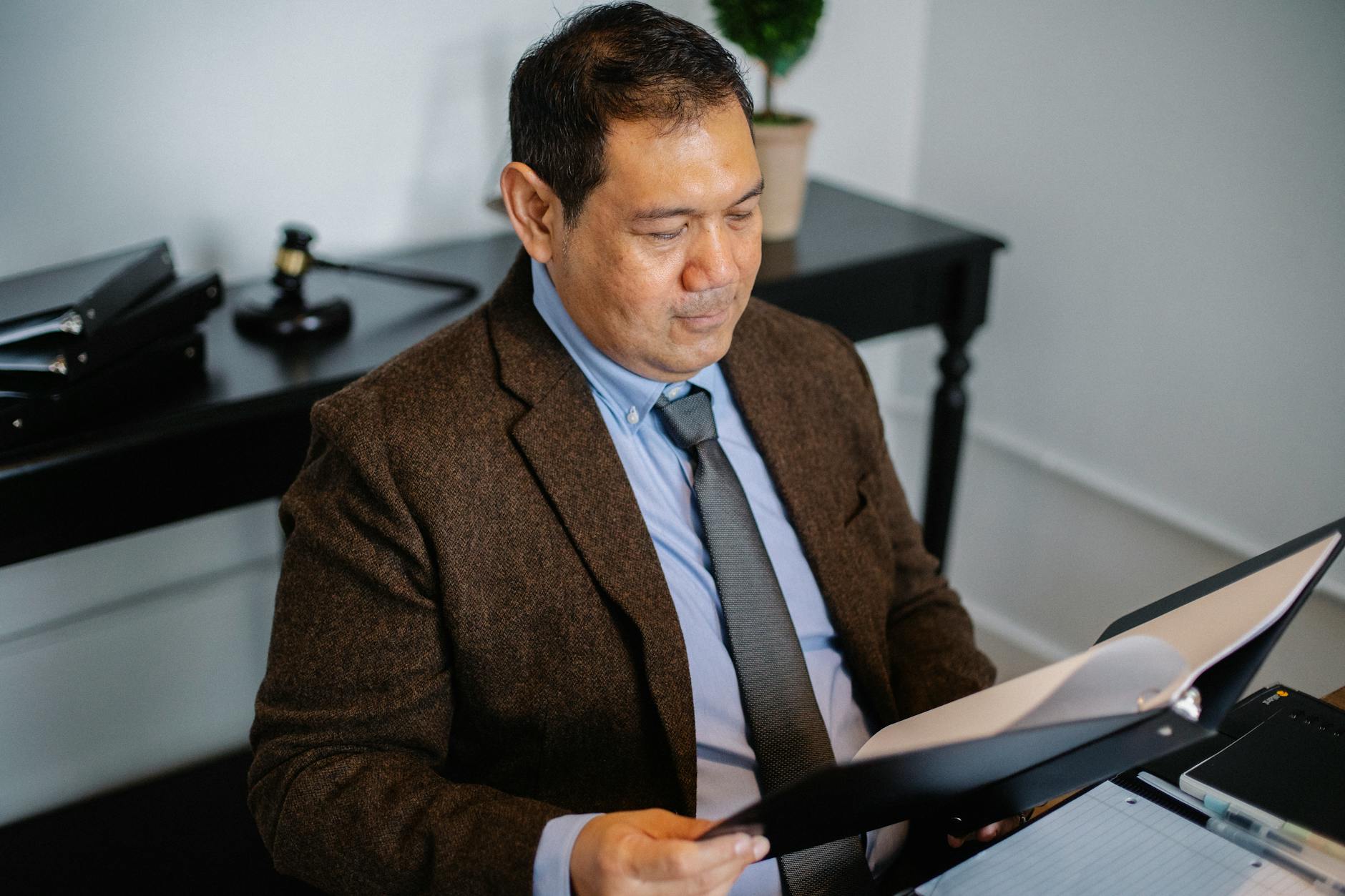 A licensed professional reviewing a Penn Mutual policy illustration at a desk