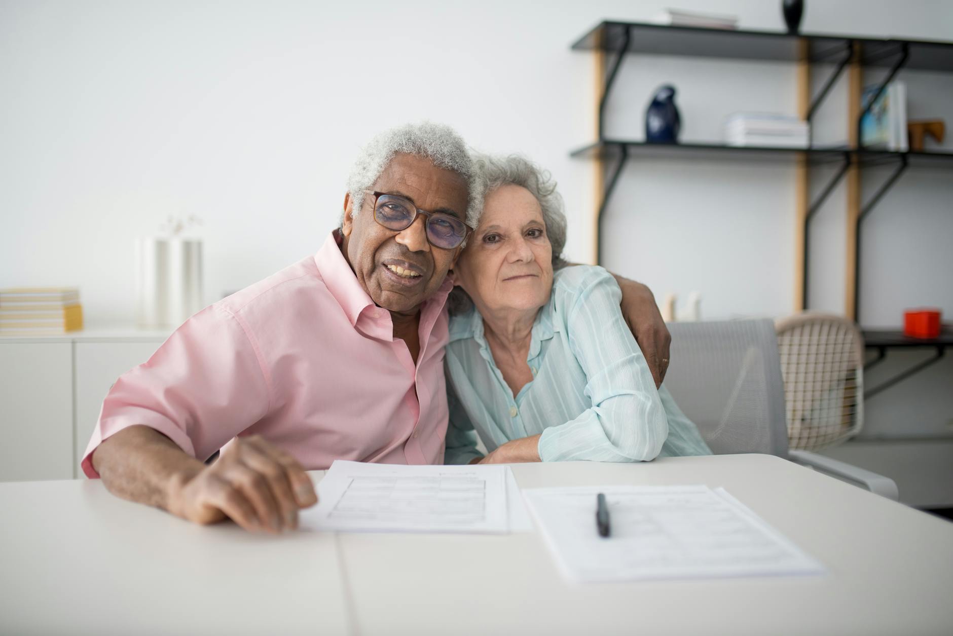 A senior couple reviewing a Senior Life Insurance Company final-expense policy with a licensed professional